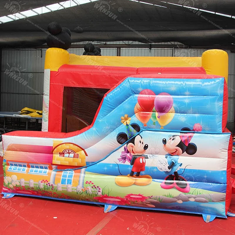 Inflatable jumping castle with slide